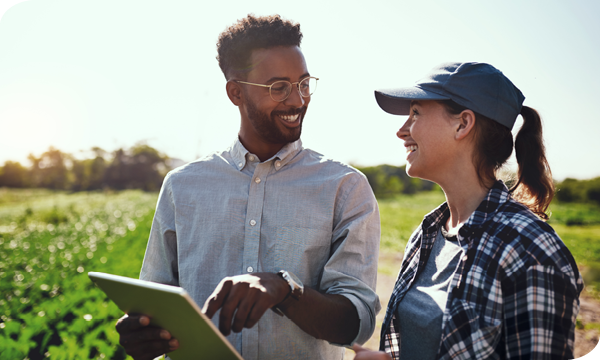 Farmer and Technician pointing at a tablet talking