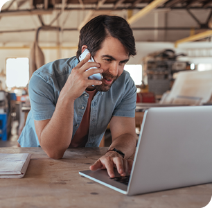 businessman talking on cellphone when using laptop businessman talking on cellphone when using laptop