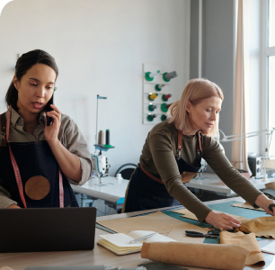 businessman talking on phone while employee is working businessman talking on phone while employee is working