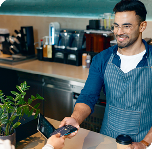 smiling businessman completing a transaction with customer using a credit card smiling businessman completing a transaction with customer using a credit card
